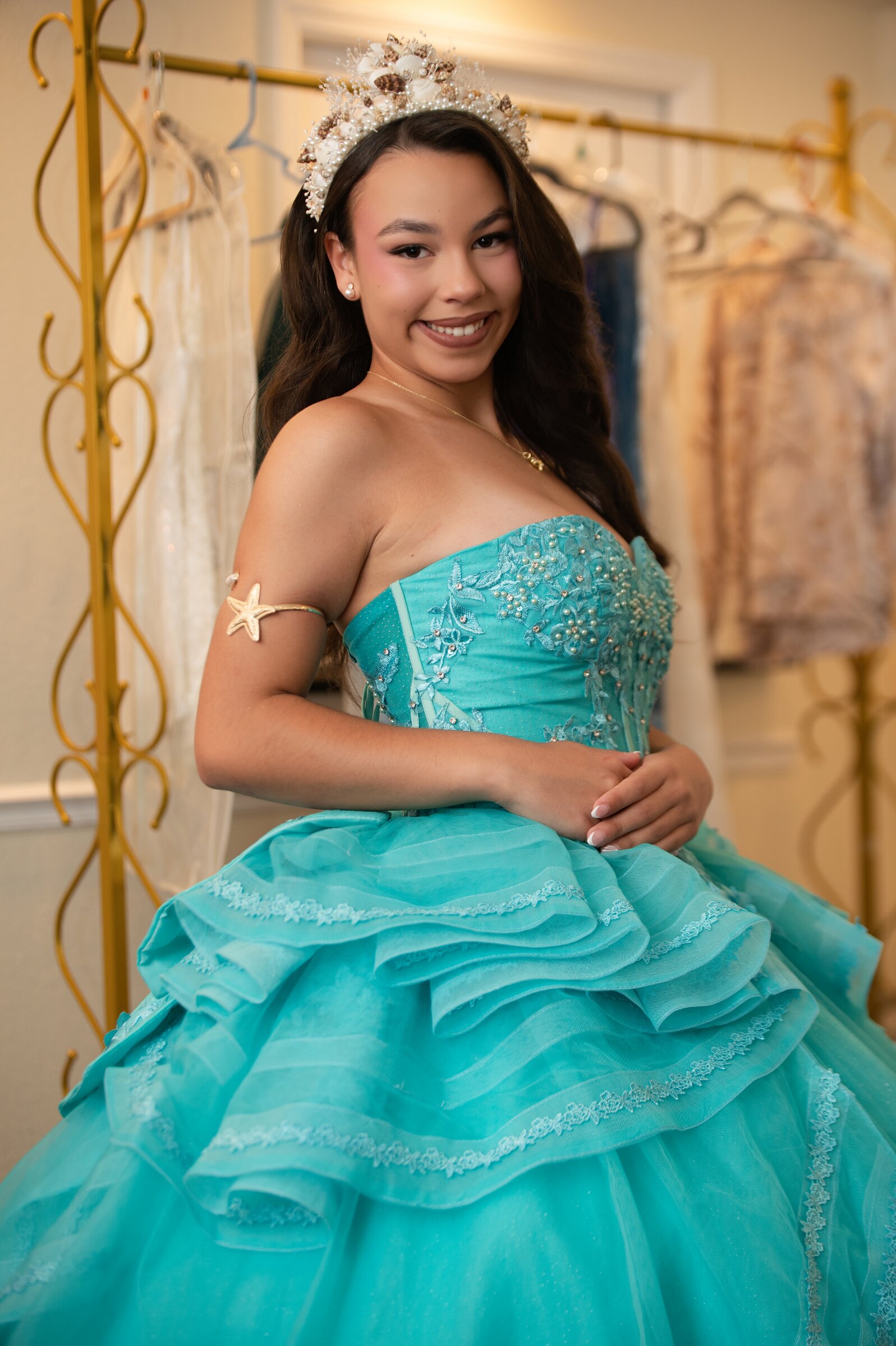Quinceañera portrait in a teal ball gown and tiara